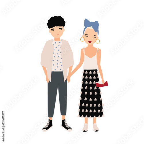 Young man and woman dressed in elegant clothes standing together