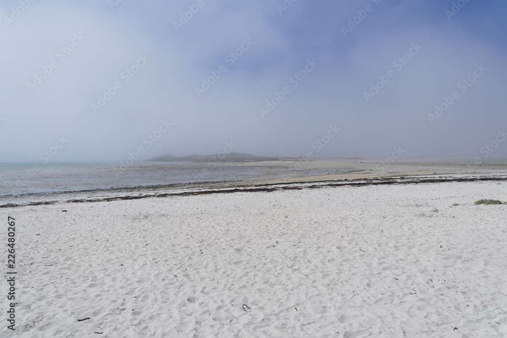 Light sea mist lingers along the white sandy beach at Landeda in Brittany.