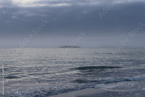 Evening brings a heavy sea mist and dark clouds over the Brittany coast.