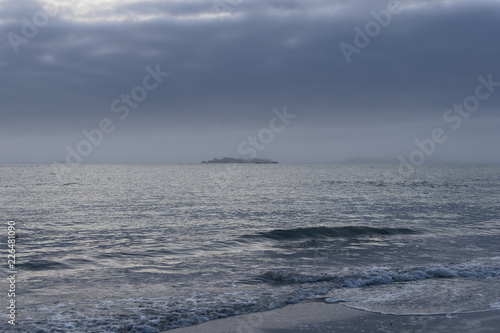 Evening brings a heavy sea mist and dark clouds over the Brittany coast. photo