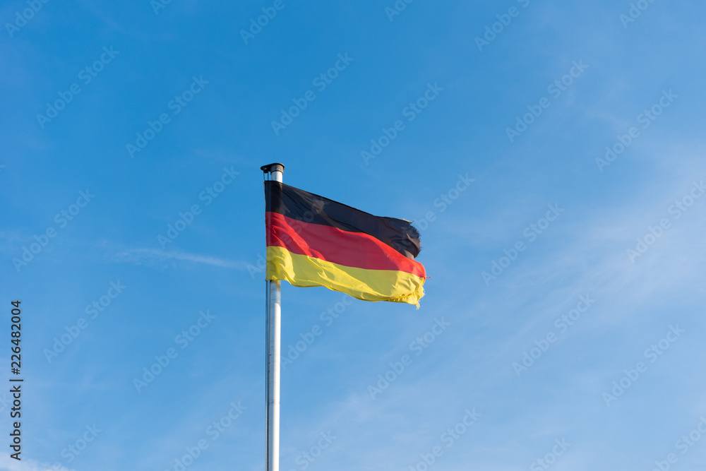 Flag of Germany against the blue sky Flag of Germany against the blue sky
