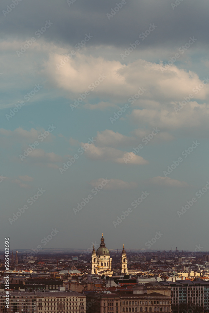 The view of Budapest with the illuminated Szent cathedral under the blue sky during the afternoon