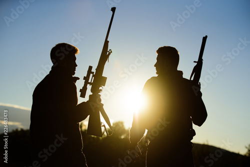 Hunter friend enjoy leisure. Hunters friends gamekeepers with guns silhouette sky background. Hunters rifles nature environment. Hunting with partner provide greater measure safety fun and rewarding