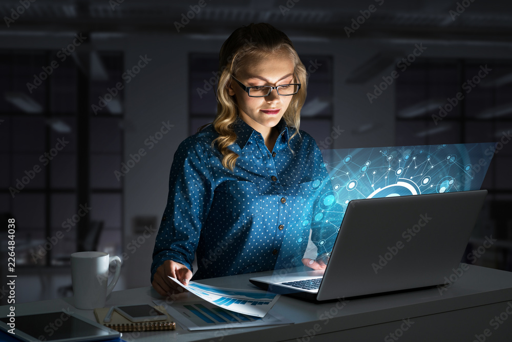 Beautiful blonde in dark office working on laptop and getting net access Beautiful blonde in dark office working on laptop and getting net access
