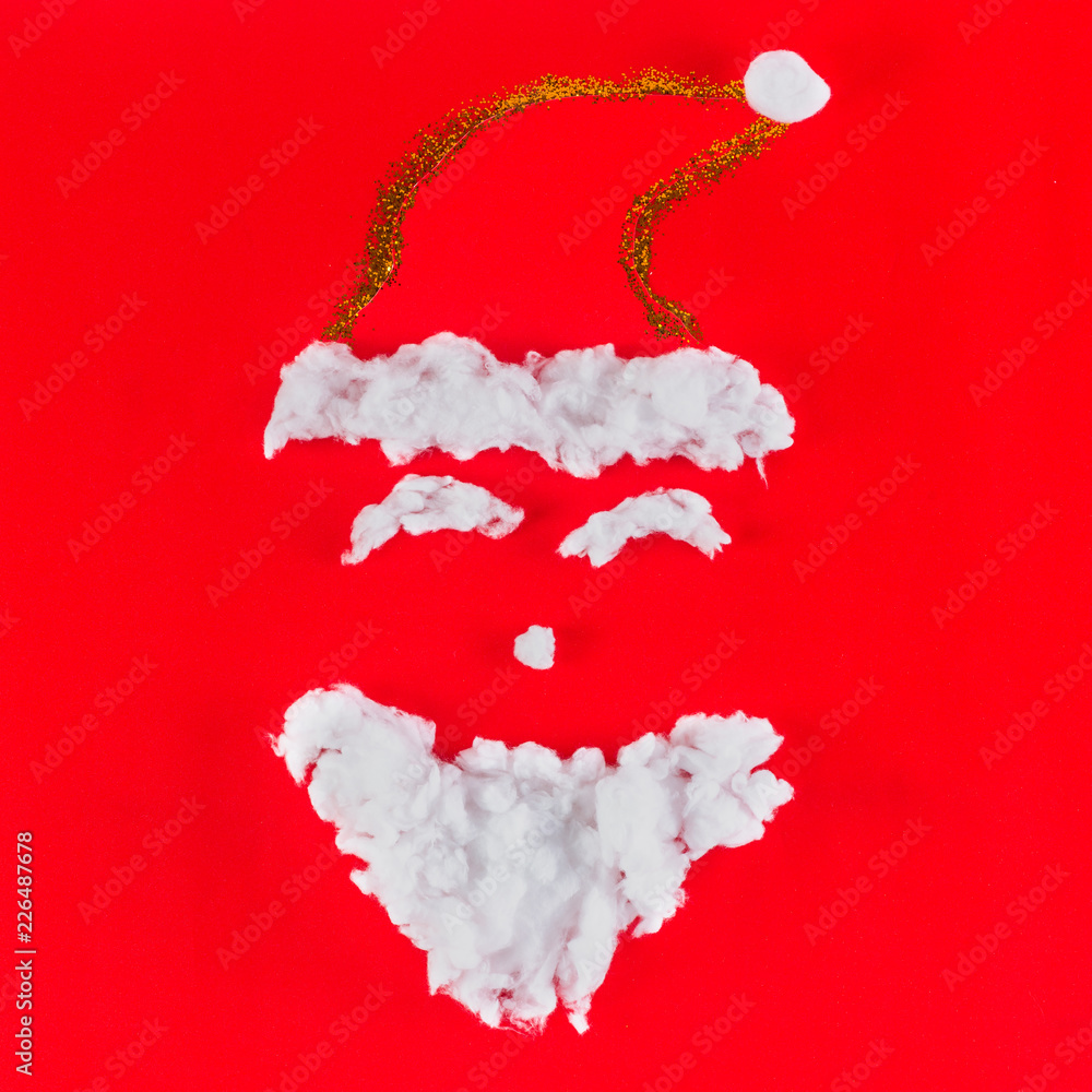 santa claus face on red background, top view santa claus face on red background, top view