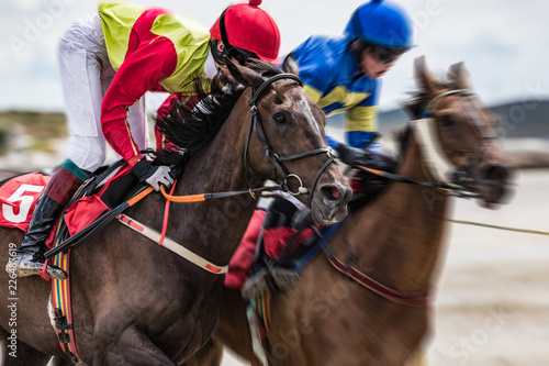 Close-up on jockey and race horse galloping at speed, motion blur zoom effect