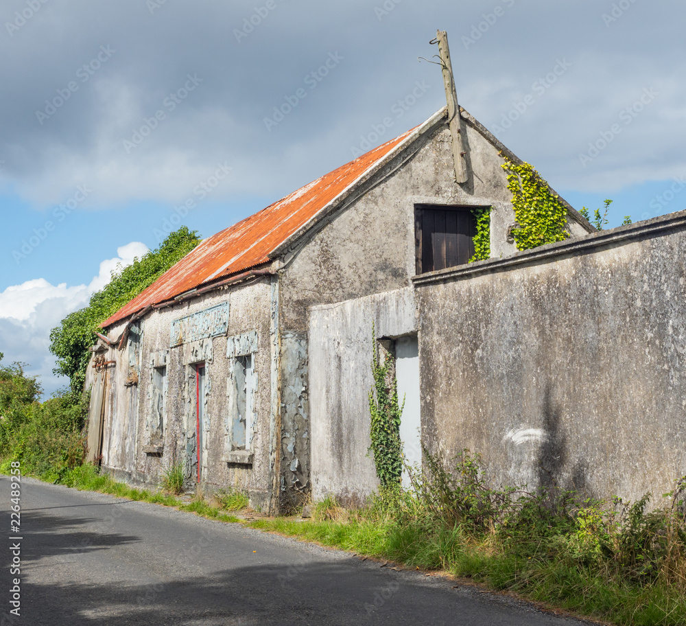 The abandoned Hannon's Stores building next to a country road near Headford, in County Galway, Ireland.
