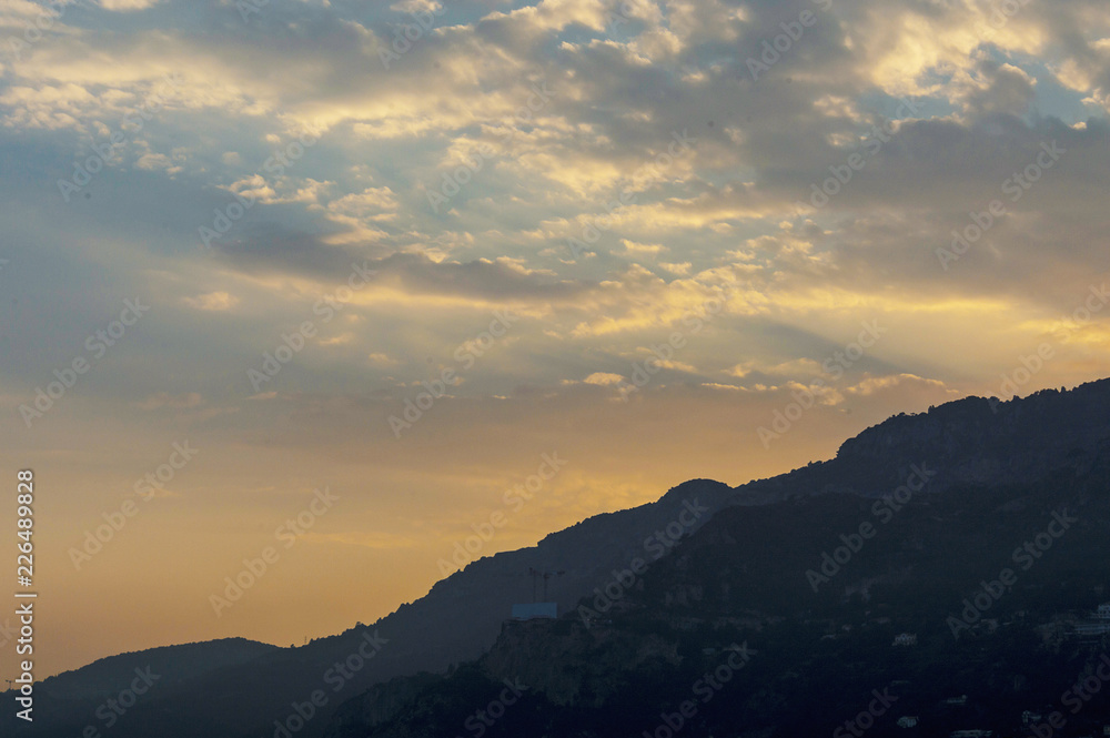 Stunning cloudy pink and white sky over Monaco at sunset in summer