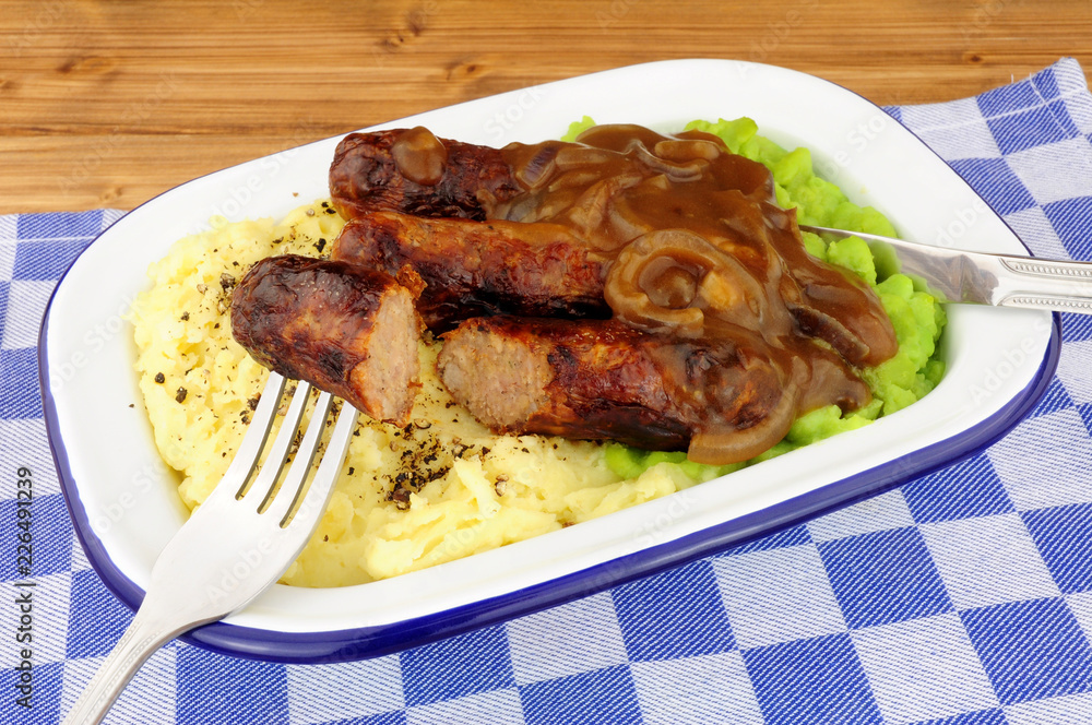Sausages and mashed potato meal with mushy peas and onion gravy Sausages and mashed potato meal with mushy peas and onion gravy