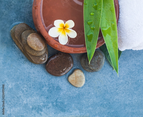Photography Top view of spa objects and stones for massage treatment on blue table background
