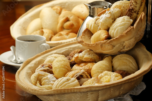 Sweet bread basket with cappuccino coffee.