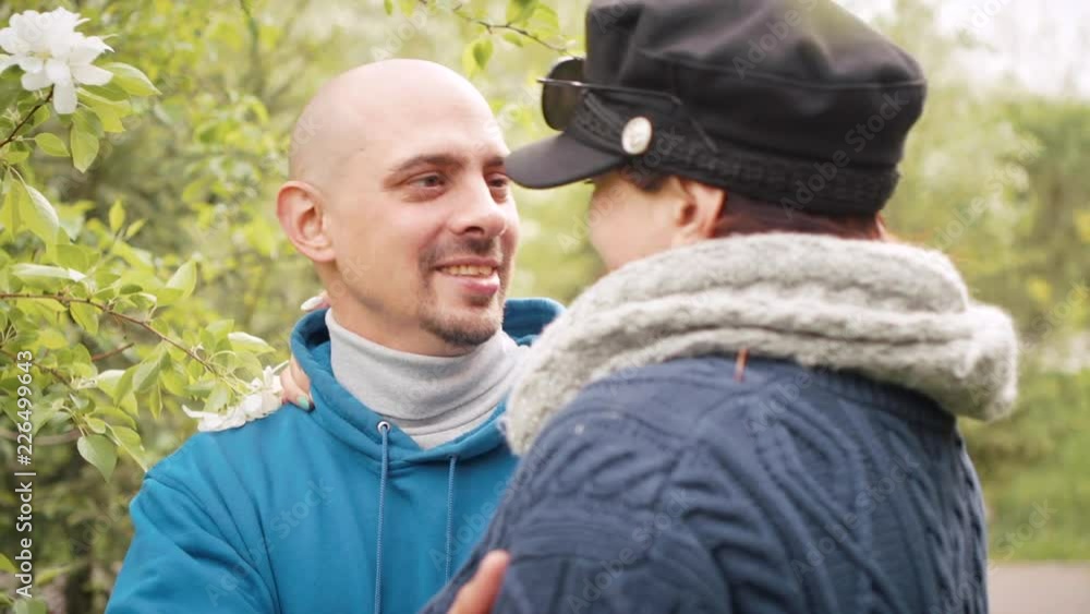 Joyful meeting of two lovers in the city park. They absorbedly talking outdoors. Joyful meeting of two lovers in the city park. They absorbedly talking outdoors.