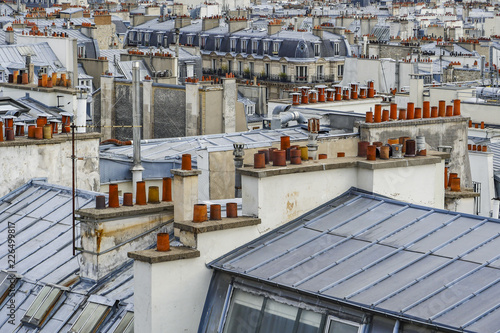Photography The roofs of Paris and its chimneys under a clouds sky