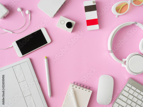 top view of office desk workspace with smartphone, notebook, graphic tablet, keyboard and mouse on pink color background, graphic designer, Creative Designer concept.