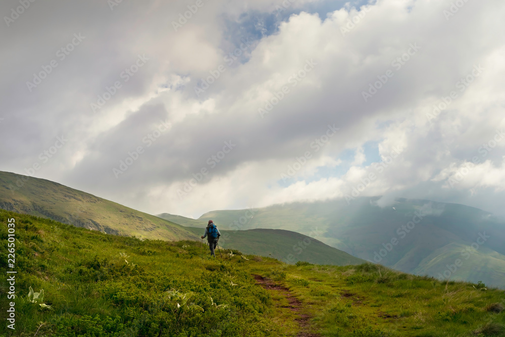 Traveler hike alone on mountain's peak.