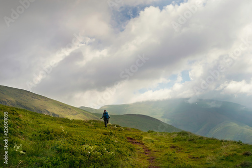 Traveler hike alone on mountain's peak.