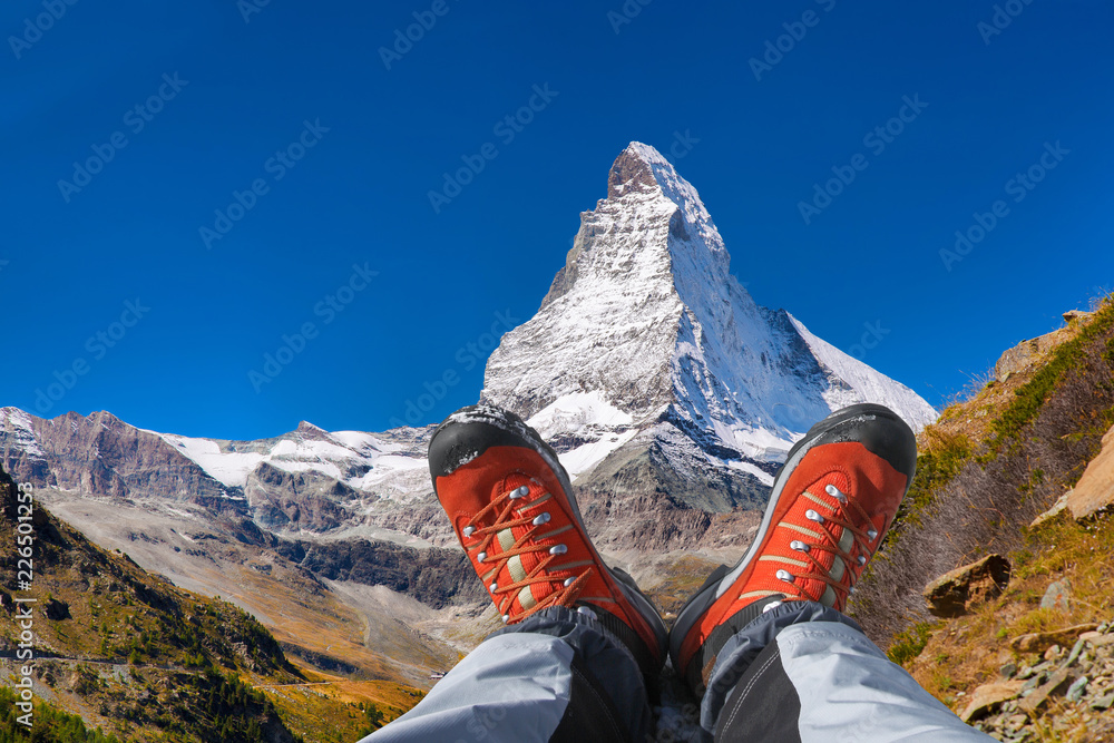 Matterhorn peak with hiking boots in Swiss Alps. Stock Photo Adobe Stock