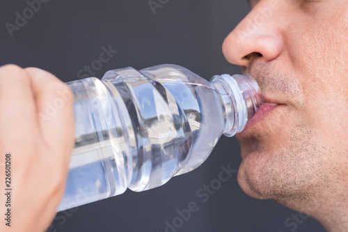 Close up of thirsty man drinking water.