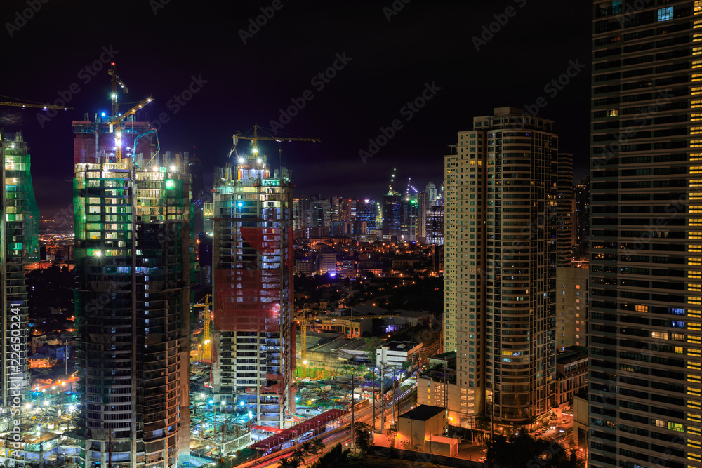 Manila at night. Buildings and cranes. Long Exposure.