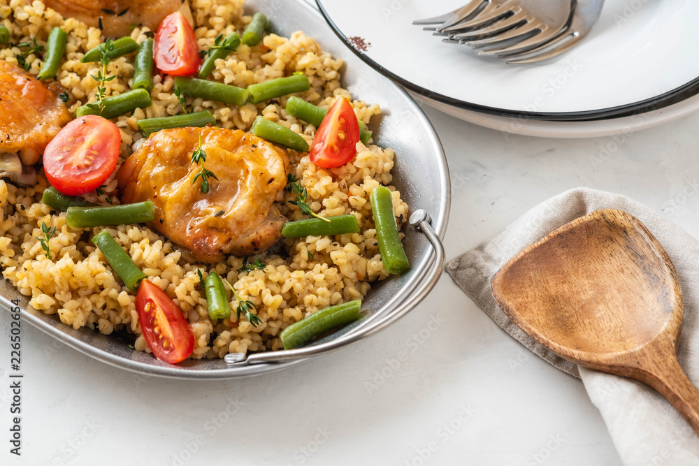 Grilled chicken thighs with bulgur, asparagus beans and tomatoes. Delicious lunch.