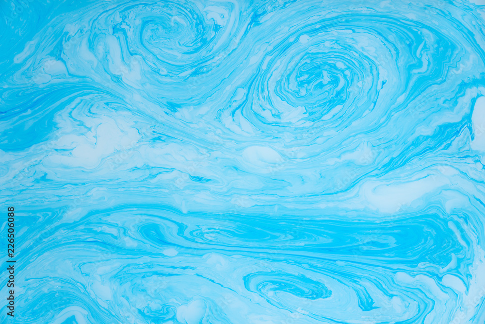 Abstract blue marble background. Stains of paint on the water. Abstract blue marble background. Stains of paint on the water.