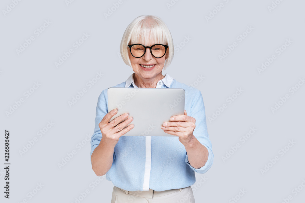 Examining her new digital tablet. Examining her new digital tablet.