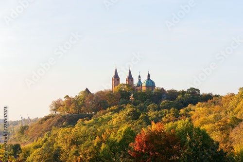 Cathedral towers amidst autumnal trees  Tumskie Hill in Plock  Poland