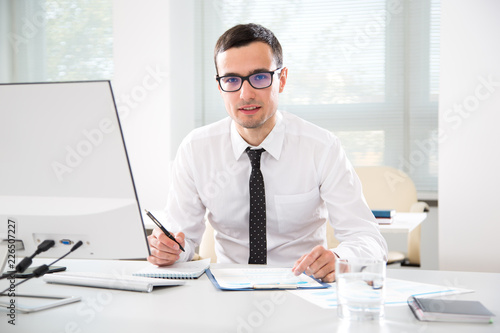 Young handsome businessman working in an office
