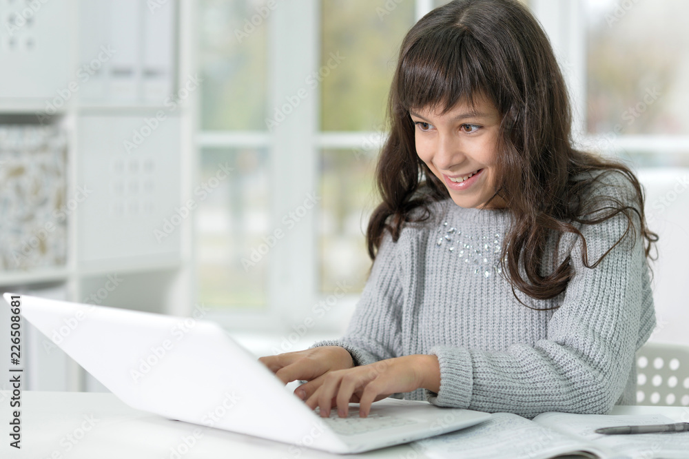 Portrait of beautiful girl with laptop studying at desk Portrait of beautiful girl with laptop studying at desk