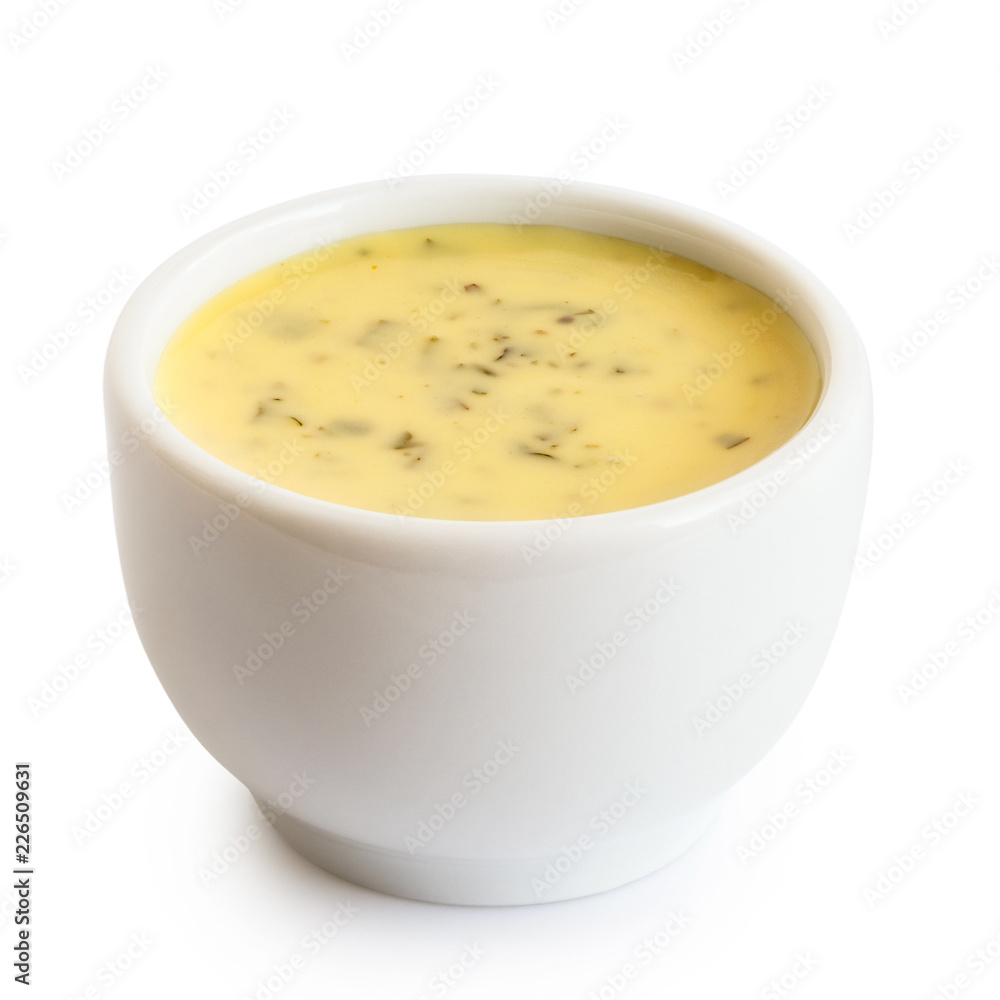 Creamy herb dressing in white ceramic condiment bowl isolated on white. Creamy herb dressing in white ceramic condiment bowl isolated on white.