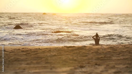 Silhouette of boy bathed in the warm ocean