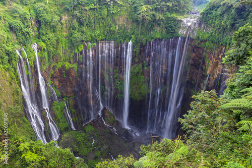 Majestic view of Tumpak Sewu Waterfall or also known as Coban Sewu, is a waterfall with 120 metres high, located in Sidomulyo Village, Pronojiwo District, Lumajang Regency, East Java, Indonesia.