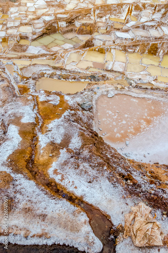 Close up of the saltpeter built in a valley on a cloudy day of Maras in Peru