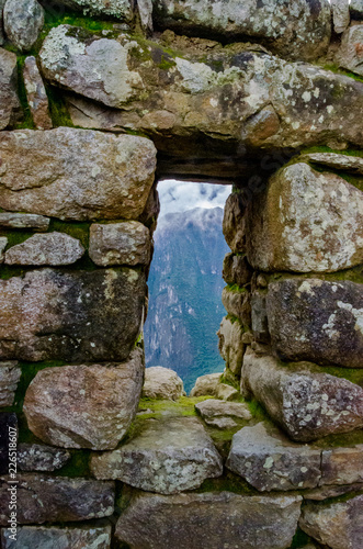 Close up on a stone window at Machu Picchu, Peru