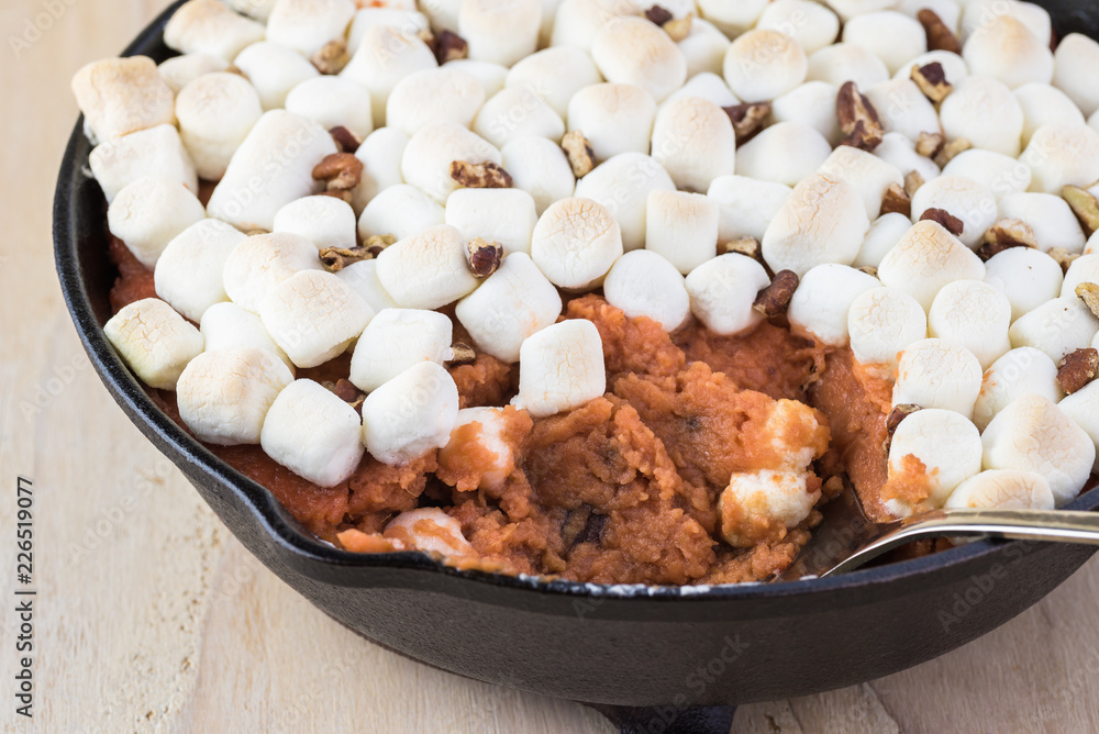 Homemade sweet potato casserole with marshmallows and pecans. Homemade sweet potato casserole with marshmallows and pecans.