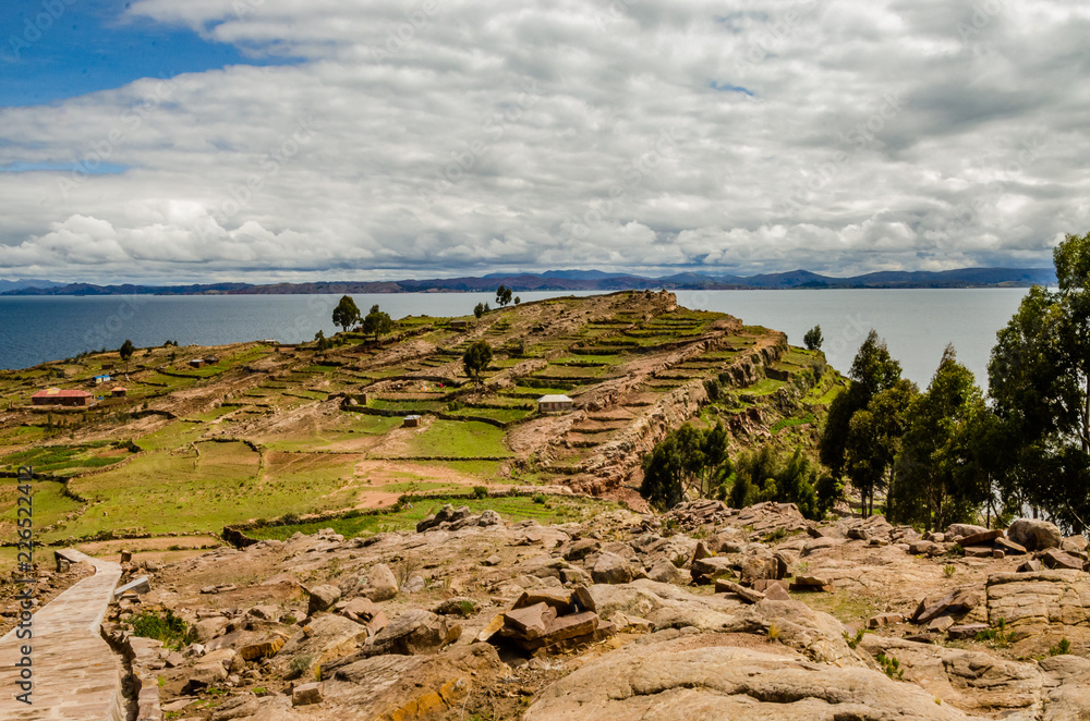 Landscape of the Taquile Island with a stone road, houses and Titikaka lake