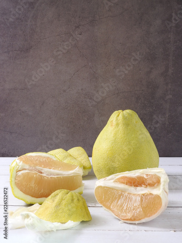 Front view of pomelo, Citrus maxima or Citrus grandis. Flesh and peel scattered . In mid-Autumn Festival, as a gift for friends and relatives. Taiwan food and fruit concept. With copy space.