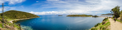 Panoramic on Isla del Sol with a blue Titikaka Lake, stones, an island and a few turists on a sunny day © LautaroFederico