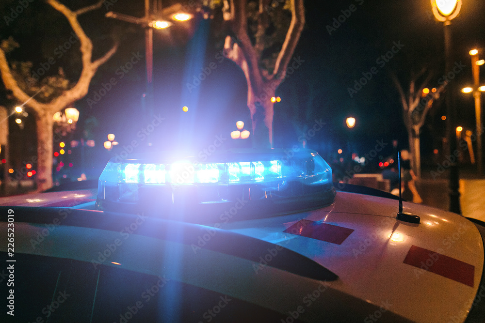 Police car with flash lights on the street at night
