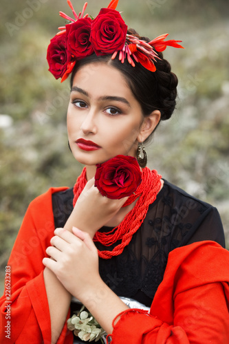 Beautiful girl with red lips and flowers.
