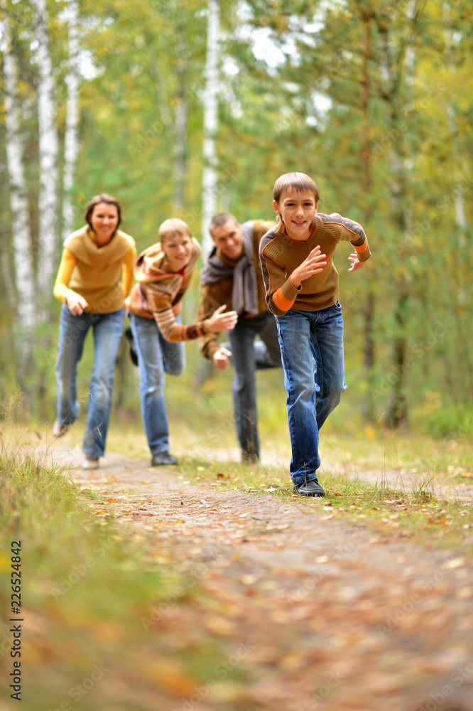 Portrait of a family of four in park Portrait of a family of four in park