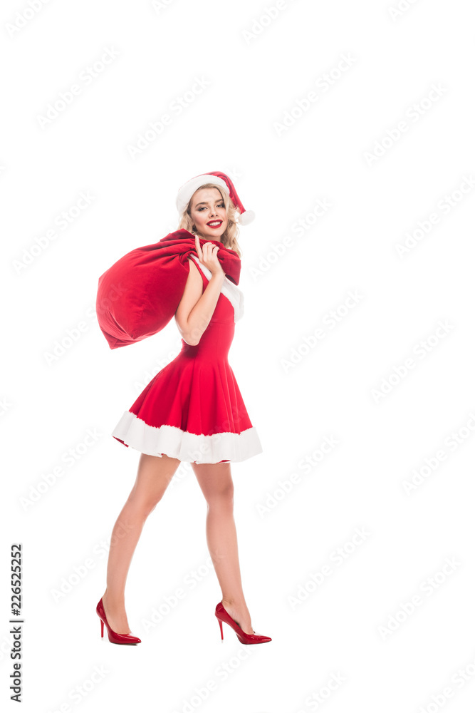 cheerful young woman in santa dress holding christmas sack over shoulder isolated on white cheerful young woman in santa dress holding christmas sack over shoulder isolated on white