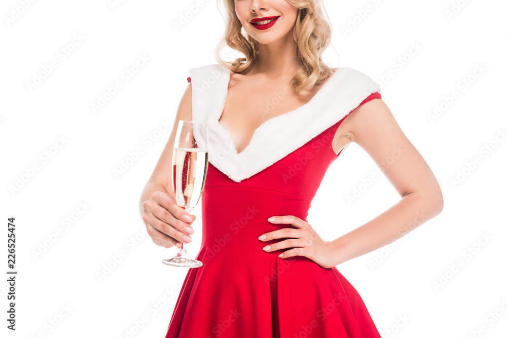partial view of young woman in christmas dress holding champagne glass isolated on white partial view of young woman in christmas dress holding champagne glass isolated on white
