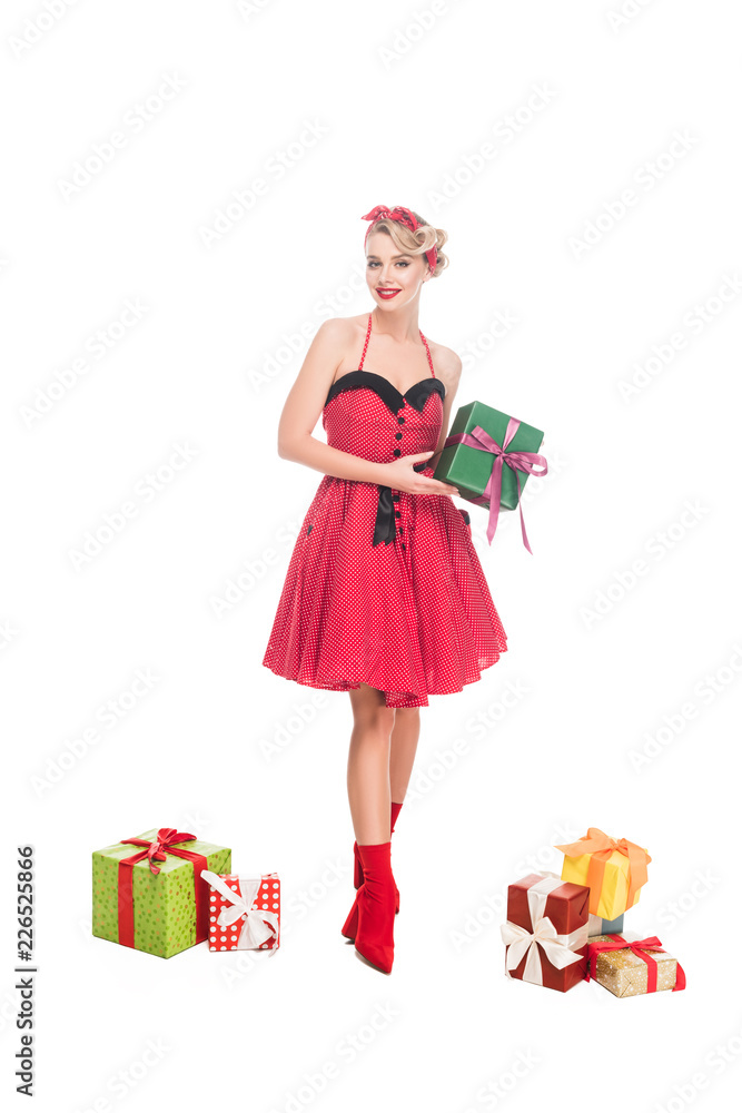 beautiful young pin up woman standing near pile of gift boxes isolated on white beautiful young pin up woman standing near pile of gift boxes isolated on white