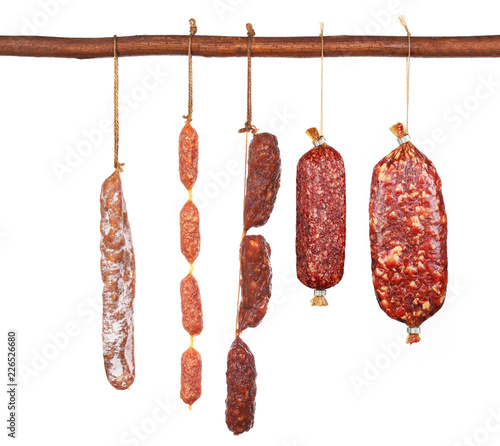 Variety of traditional mini salami isolated on white background