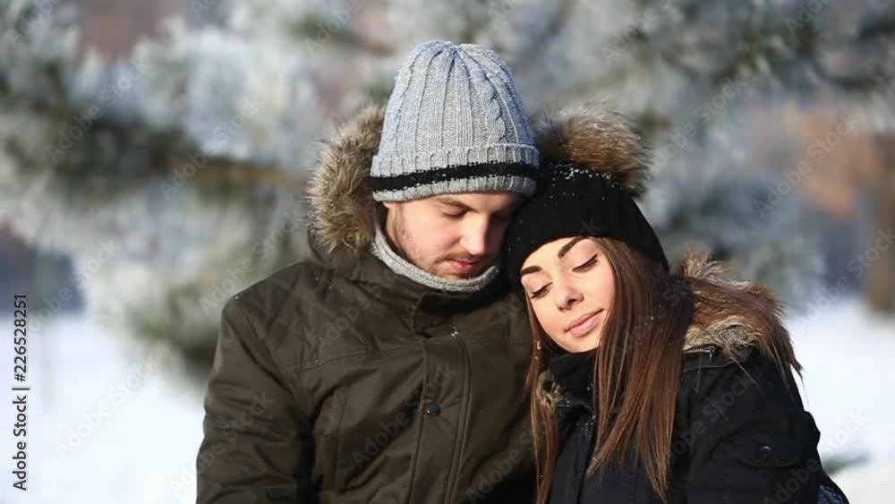 Happy couple playful together during winter holidays vocation outside in snow park. close up view Happy couple playful together during winter holidays vocation outside in snow park. close up view