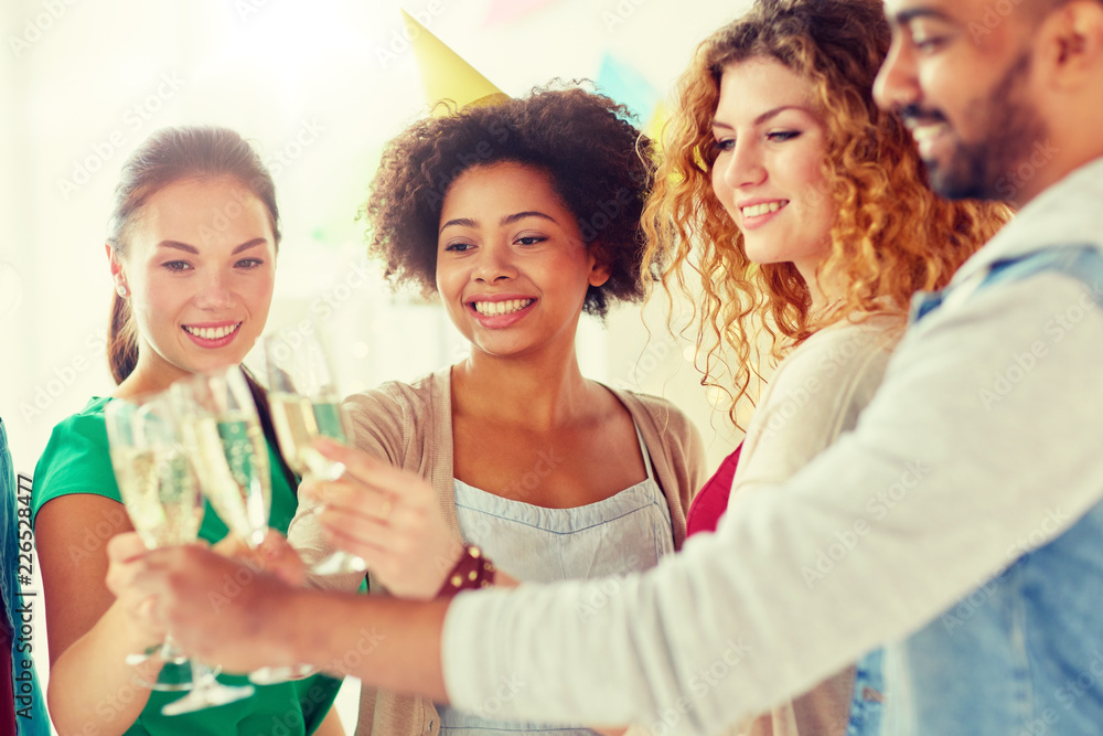 celebration, people and holidays concept - happy friends clinking glasses of champagne at birthday party celebration, people and holidays concept - happy friends clinking glasses of champagne at birthday party
