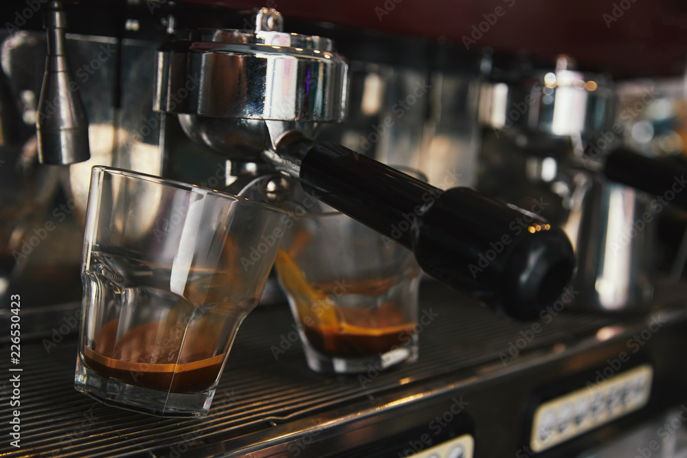 close-up of coffee maker preparing espresso in two cups close-up of coffee maker preparing espresso in two cups