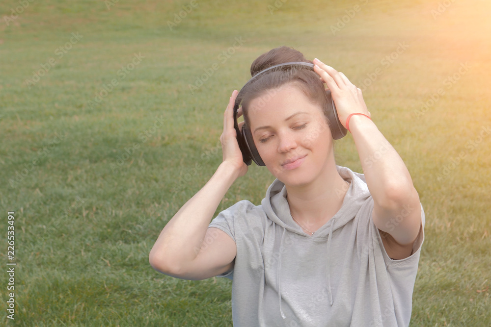 Beautiful caucasian woman in headphones enjoying the music