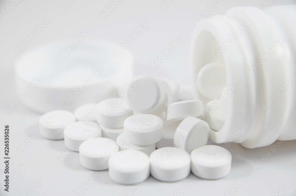 white pill on white blackground with bottle white pill on white blackground with bottle